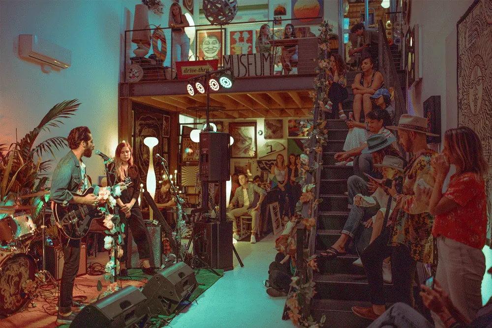 A band playing to a packed room at BudmanStudio