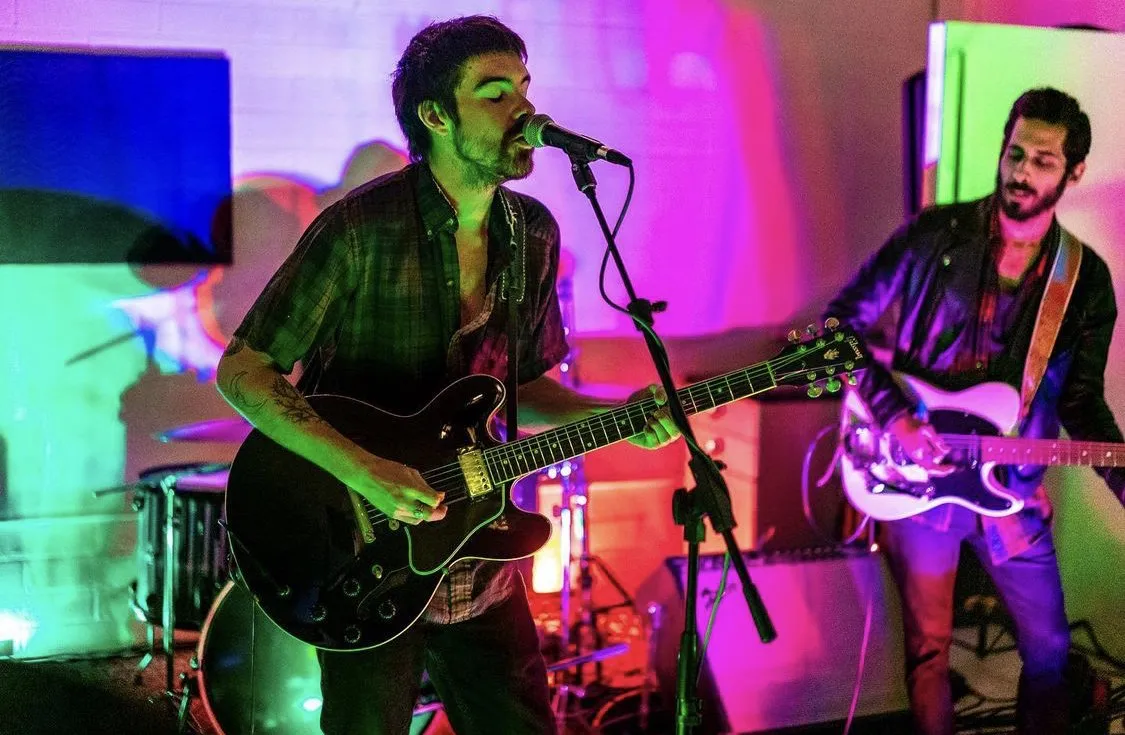 Two guitarists under colored light at BudmanStudio