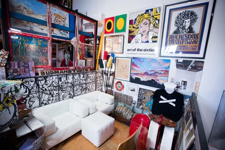 White couches and framed art at BudmanStudio