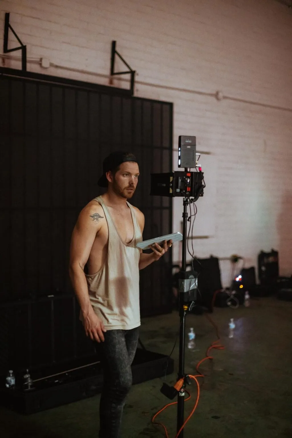 Jake Goble on set holding a tablet beside a camera rig