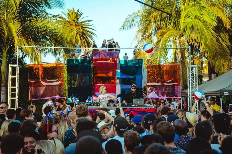 The SamJam stage and crowd under palm trees